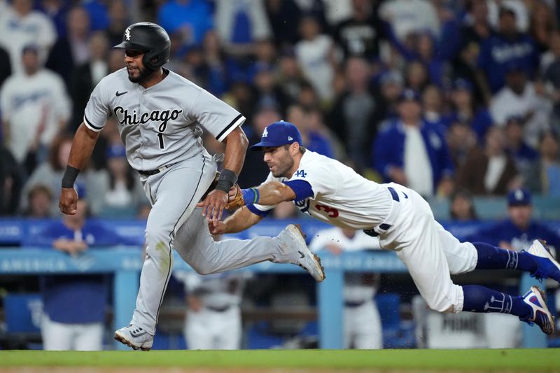 Jun 15, 2023; Los Angeles, California, USA; Chicago White Sox shortstop Elvis Andrus (1) is tagged out by Los Angeles Dodgers third baseman Chris Taylor (3) while attempting to steal home plate in the seventh inning at Dodger Stadium. Mandatory Credit: Kirby Lee-USA TODAY Sports