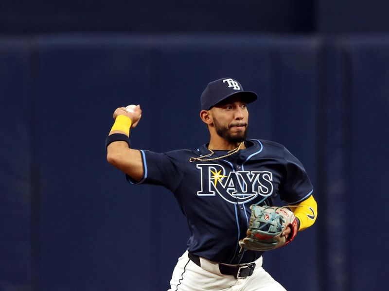Apr 2, 2024; St. Petersburg, Florida, USA; Tampa Bay Rays shortstop Jose Caballero (7) throws the ball to first base for an out during the first inning against the Texas Rangers at Tropicana Field. Mandatory Credit: Kim Klement Neitzel-USA TODAY Sports