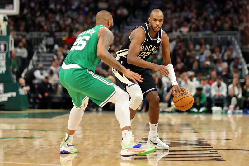 MILWAUKEE, WISCONSIN - APRIL 09: Khris Middleton #22 of the Milwaukee Bucks is defended by Xavier Tillman #26 of the Boston Celtics during a game at Fiserv Forum on April 09, 2024 in Milwaukee, Wisconsin. NOTE TO USER: User expressly acknowledges and agrees that, by downloading and or using this photograph, User is consenting to the terms and conditions of the Getty Images License Agreement. (Photo by Stacy Revere/Getty Images)