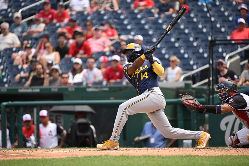 Aug 4, 2024; Washington, District of Columbia, USA; Milwaukee Brewers third baseman Andruw Monasterio (14) hits the ball into play against the Washington Nationals during the fifth inning at Nationals Park. Mandatory Credit: Rafael Suanes-USA TODAY Sports