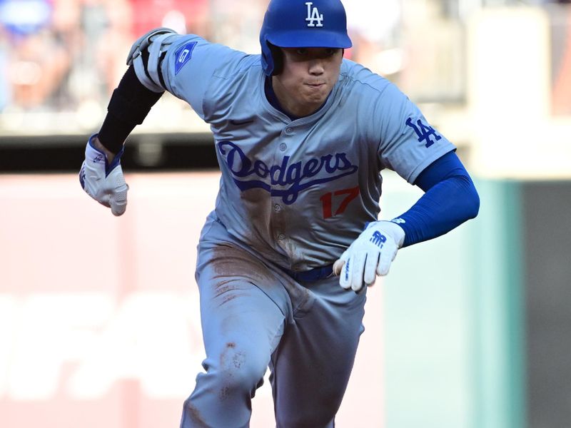 Aug 17, 2024; St. Louis, Missouri, USA; Los Angeles Dodgers designated hitter Shohei Ohtani (17) tags up and digs for third base against the St. Louis Cardinals in the first inning at Busch Stadium. Mandatory Credit: Tim Vizer-USA TODAY Sports