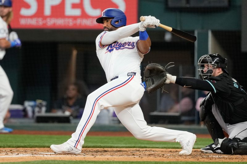 May 29, 2024; Arlington, Texas, USA; Texas Rangers second baseman Ezequiel Duran (20) follows through on his single against the Arizona Diamondbacks during the fifth inning at Globe Life Field. Mandatory Credit: Jim Cowsert-USA TODAY Sports