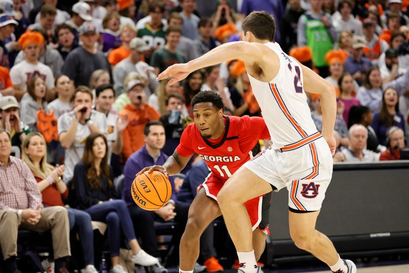 Feb 1, 2023; Auburn, Alabama, USA;  Georgia Bulldogs guard Justin Hill (11) tries to go around Auburn Tigers guard Lior Berman (24) during the first half at Neville Arena. Mandatory Credit: John Reed-USA TODAY Sports