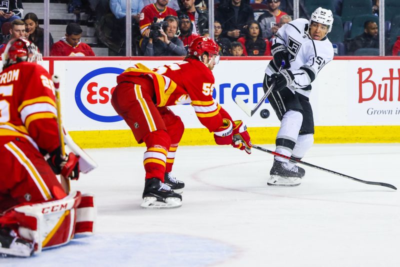 Mar 28, 2023; Calgary, Alberta, CAN; Los Angeles Kings center Quinton Byfield (55) shoot the puck against the Calgary Flames during the third period at Scotiabank Saddledome. Mandatory Credit: Sergei Belski-USA TODAY Sports