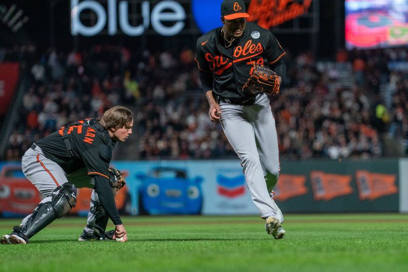 Jun 2, 2023; San Francisco, California, USA;  Baltimore Orioles catcher Adley Rutschman (35) fields a soft ground ball during the eighth inning against the San Francisco Giants at Oracle Park. Mandatory Credit: Neville E. Guard-USA TODAY Sports