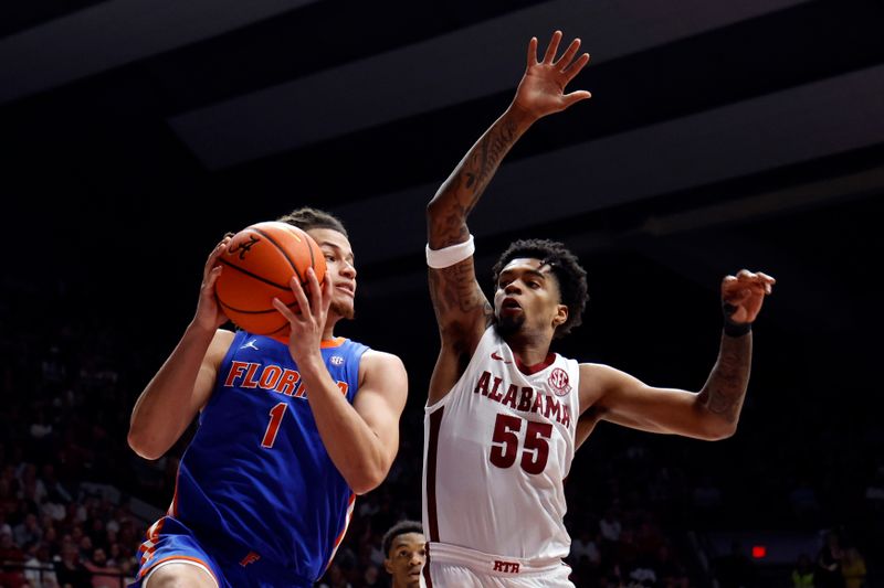 Feb 21, 2024; Tuscaloosa, Alabama, USA; Florida Gators guard Walter Clayton Jr. (1) goes up for a lay up as Alabama Crimson Tide guard Aaron Estrada (55) defends  during the second half at Coleman Coliseum. Mandatory Credit: Butch Dill-USA TODAY Sports