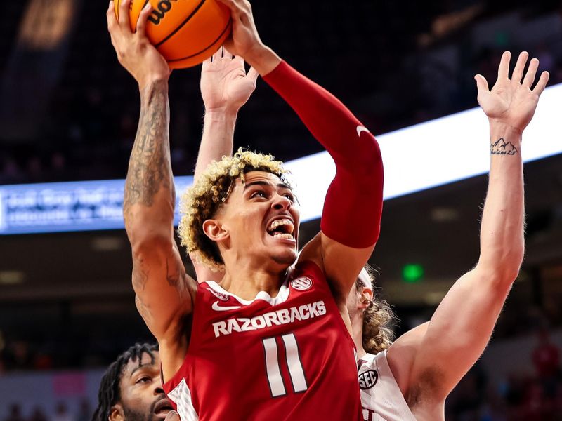 Feb 4, 2023; Columbia, South Carolina, USA; Arkansas Razorbacks forward Jalen Graham (11) shoots over South Carolina Gamecocks forward Hayden Brown (10) in the first half at Colonial Life Arena. Mandatory Credit: Jeff Blake-USA TODAY Sports