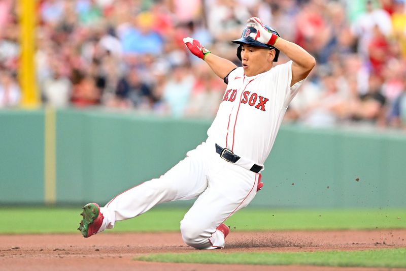 Jun 25, 2024; Boston, Massachusetts, USA; Boston Red Sox left fielder Masataka Yoshida (7) slides into second base after hitting a RBI double against the Toronto Blue Jays during the second inning at Fenway Park. Mandatory Credit: Brian Fluharty-USA TODAY Sports