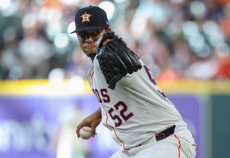 May 24, 2025; Houston, Texas, USA; Houston Astros relief pitcher Bryan Abreu (52) delivers a pitch during the eighth inning against the Seattle Mariners at Daikin Park. Mandatory Credit: Troy Taormina-Imagn Images