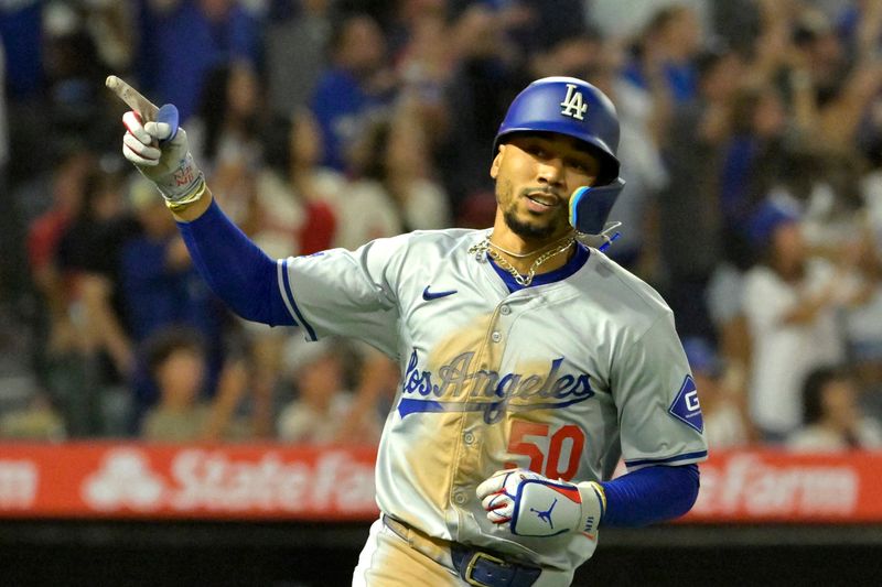 Sep 3, 2024; Anaheim, California, USA;  Los Angeles Dodgers shortstop Mookie Betts (50) celebrates as he rounds the bases after hitting a three-run home run in the tenth inning against the Los Angeles Angels at Angel Stadium. Mandatory Credit: Jayne Kamin-Oncea-Imagn Images