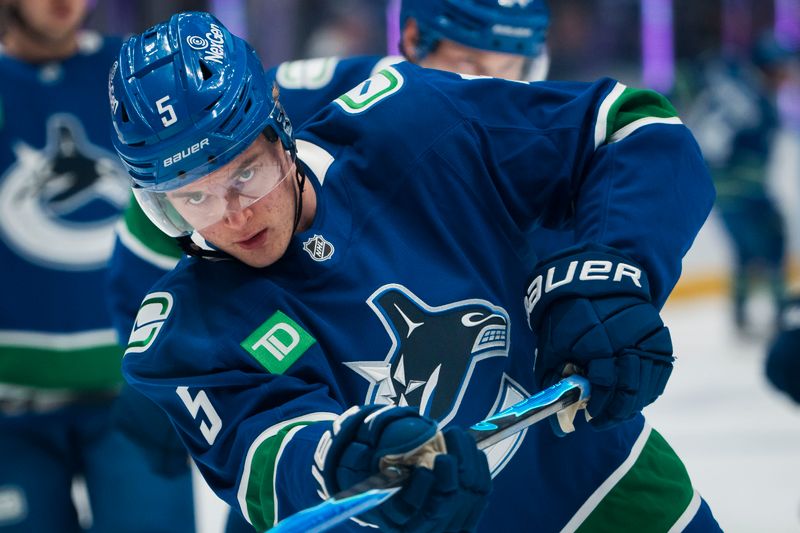 Nov 8, 2025; Vancouver, British Columbia, CAN; Vancouver Canucks defenseman Tom Willander (5) shoots during warm up prior to a game against the Columbus Blue Jackets at Rogers Arena. Mandatory Credit: Bob Frid-Imagn Images