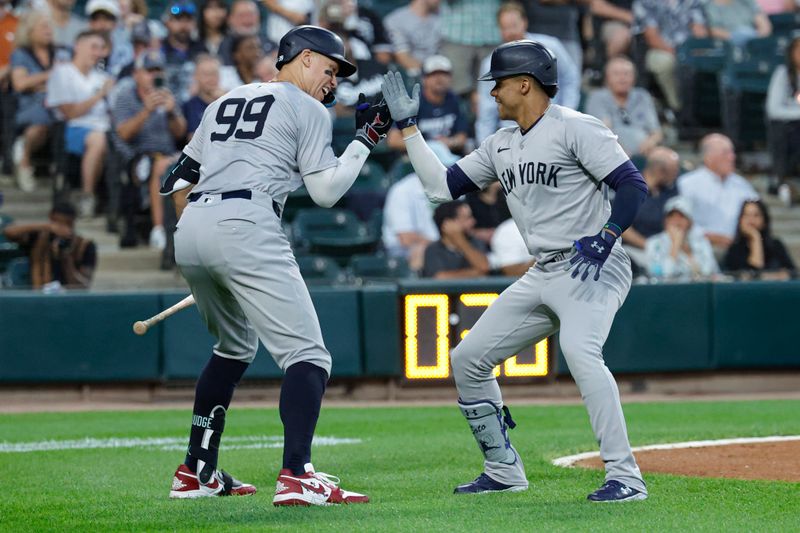 Aug 13, 2024; Chicago, Illinois, USA; New York Yankees outfielder Juan Soto (22) celebrates with outfielder Aaron Judge (99) after hitting a two-run home run against the Chicago White Sox during the third inning at Guaranteed Rate Field. Mandatory Credit: Kamil Krzaczynski-USA TODAY Sports