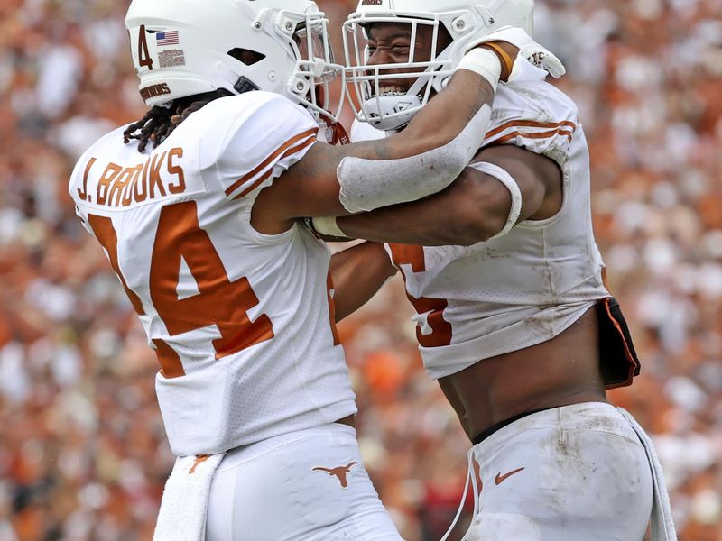 Oct 8, 2022; Dallas, Texas, USA;  Texas Longhorns running back Jonathon Brooks (24) celebrates with Texas Longhorns running back Bijan Robinson (5) after scoring a touchdown during the second half against the Oklahoma Sooners at the Cotton Bowl. Mandatory Credit: Kevin Jairaj-USA TODAY Sports