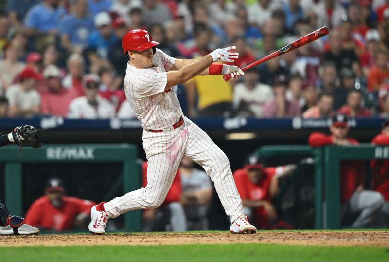 Aug 17, 2024; Philadelphia, Pennsylvania, USA; Philadelphia Phillies catcher J.T. Realmuto (10) hits an RBI single against the Washington Nationals in the sixth inning at Citizens Bank Park. Mandatory Credit: Kyle Ross-USA TODAY Sports