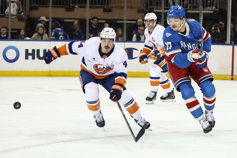 Nov 8, 2025; New York, New York, USA;  New York Islanders center Jean-Gabriel Pageau (44) and New York Rangers defenseman Will Borgen (17) chase after the puck in the second period at Madison Square Garden. Mandatory Credit: Wendell Cruz-Imagn Images