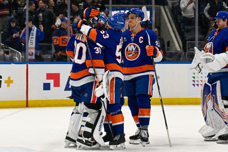 Jan 6, 2026; Elmont, New York, USA; New York Islanders center Casey Cizikas (53) celebrate the 9-0 victory with New York Islanders goaltender Ilya Sorokin (30) against the New Jersey Devils after the game at UBS Arena. Mandatory Credit: Dennis Schneidler-Imagn Images