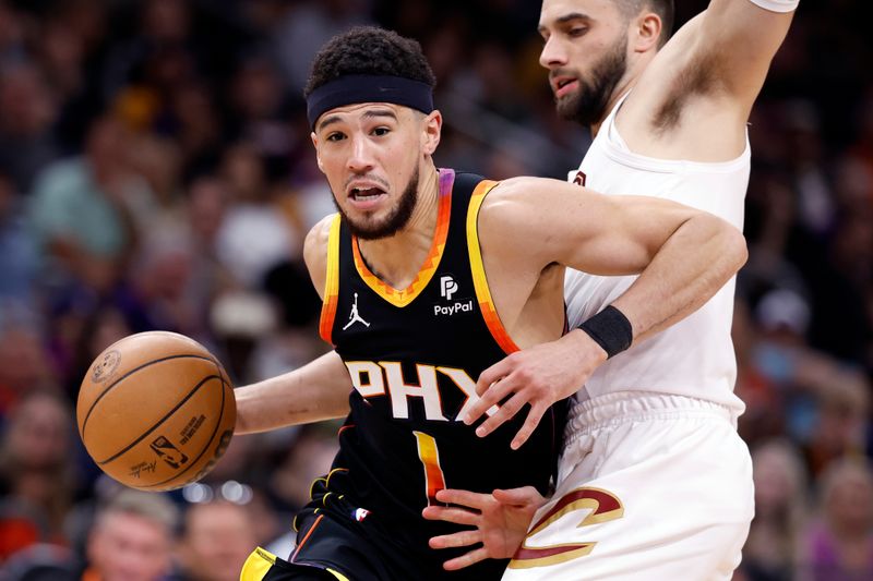 PHOENIX, ARIZONA - APRIL 03: Devin Booker #1 of the Phoenix Suns drives to the basket against Max Strus #1 of the Cleveland Cavaliers during the second half at Footprint Center on April 03, 2024 in Phoenix, Arizona. NOTE TO USER: User expressly acknowledges and agrees that, by downloading and or using this photograph, User is consenting to the terms and conditions of the Getty Images License Agreement.  (Photo by Chris Coduto/Getty Images)