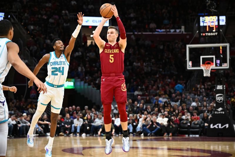 CLEVELAND, OHIO - MARCH 25: Sam Merrill #5 of the Cleveland Cavaliers shoots against Brandon Miller #24 of the Charlotte Hornets during the first quarter at Rocket Mortgage Fieldhouse on March 25, 2024 in Cleveland, Ohio. NOTE TO USER: User expressly acknowledges and agrees that, by downloading and or using this photograph, User is consenting to the terms and conditions of the Getty Images License Agreement. (Photo by Jason Miller/Getty Images)