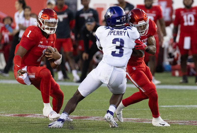 Sep 16, 2023; Houston, Texas, USA; Houston Cougars quarterback Donovan Smith (1) rushes against TCU Horned Frogs safety Mark Perry (3) in the first half at TDECU Stadium. Mandatory Credit: Thomas Shea-USA TODAY Sports