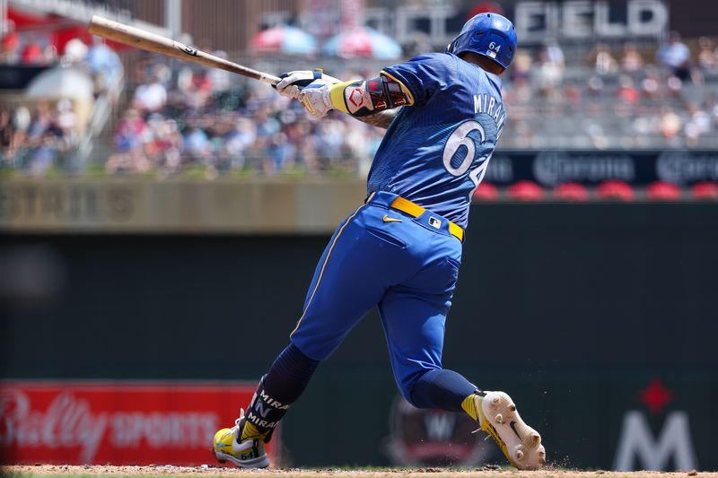 Jul 6, 2024; Minneapolis, Minnesota, USA; Minnesota Twins third baseman Jose Miranda (64) hits a single against the Houston Astros setting the longest streak in the MLB expansion era with hits in 12 straight at bats during the fourth inning at Target Field. Mandatory Credit: Matt Krohn-USA TODAY Sports