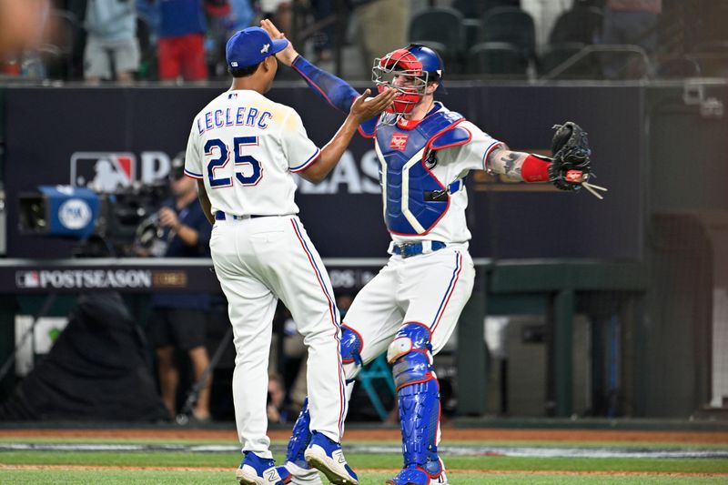 Oct 10, 2023; Arlington, Texas, USA; Texas Rangers relief pitcher Jose Leclerc (25) and catcher Jonah Heim (28) celebrate after defeating the Baltimore Orioles in game three of the ALDS for the 2023 MLB playoffs at Globe Life Field. Mandatory Credit: Jerome Miron-USA TODAY Sports