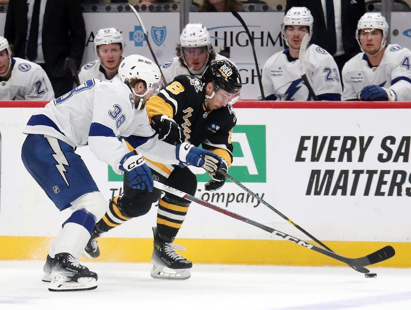 Nov 19, 2024; Pittsburgh, Pennsylvania, USA; Pittsburgh Penguins left wing Michael Bunting (8) skates with the puck against Tampa Bay Lightning left wing Brandon Hagel (38) during the third period at PPG Paints Arena. Mandatory Credit: Charles LeClaire-Imagn Images