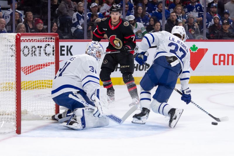 Feb 10, 2024; Ottawa, Ontario, CAN; Toronto Maple Leafs defenseman Timothy Liljegren (27) clears the puck as Ottawa Senators center Ridly Greig (71) looks on in the first period at the Canadian Tire Centre. Mandatory Credit: Marc DesRosiers-USA TODAY Sports