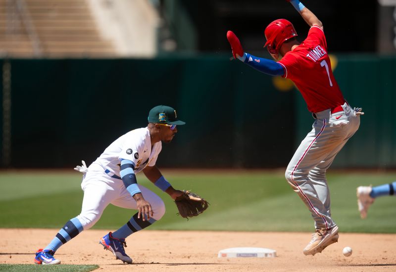 Jun 18, 2023; Oakland, California, USA; Philadelphia Phillies shortstop Trea Turner (7) leaps to avoid the tag of Oakland Athletics second baseman Tony Kemp (5) during the eighth inning at Oakland-Alameda County Coliseum. Mandatory Credit: D. Ross Cameron-USA TODAY Sports