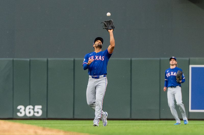 May 24, 2024; Minneapolis, Minnesota, USA; Texas Rangers second base Marcus Semien (2) catches a popup hit by Minnesota Twins center fielder Byron Buxton (25) in the fifth inning at Target Field. Mandatory Credit: Matt Blewett-USA TODAY Sports