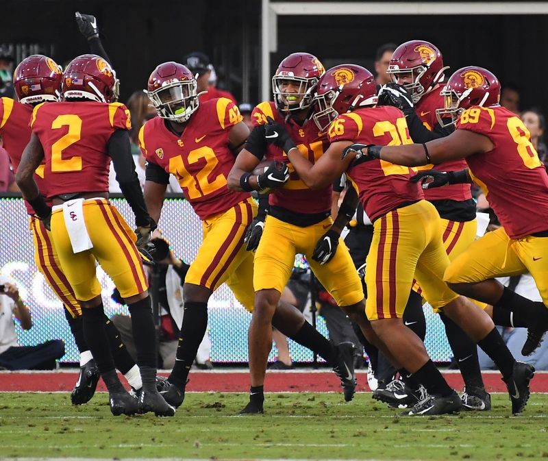 Nov 2, 2019; Los Angeles, CA, USA;   USC Trojans safety Isaiah Pola-Mao (21) is swarmed after catching an interception in the first quarter of the game against the Oregon Ducks at Los Angeles Memorial Coliseum. Mandatory Credit: Jayne Kamin-Oncea-USA TODAY Sports