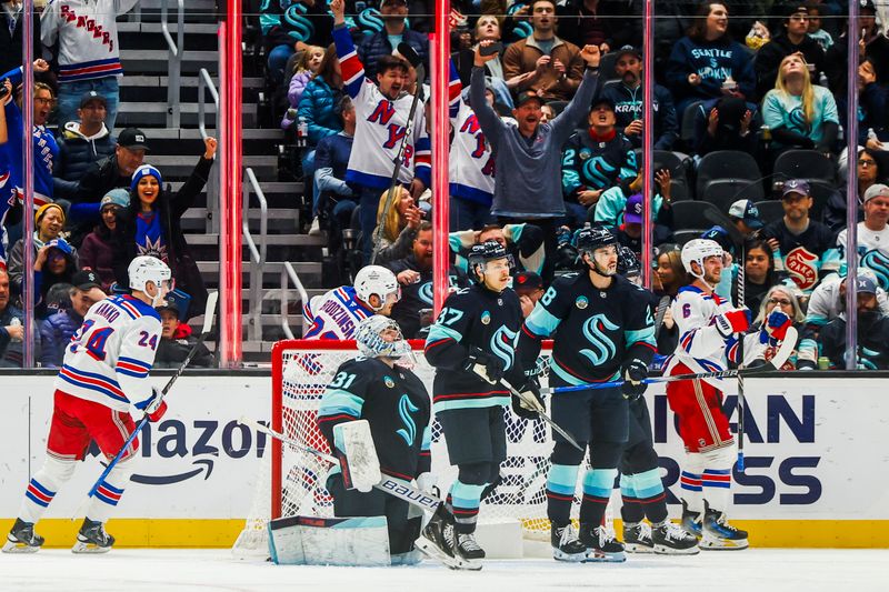 Nov 17, 2024; Seattle, Washington, USA; New York Rangers defenseman Zac Jones (6, right) celebrates after scoring a goal against Seattle Kraken goaltender Philipp Grubauer (31) during the third period at Climate Pledge Arena. Mandatory Credit: Joe Nicholson-Imagn Images