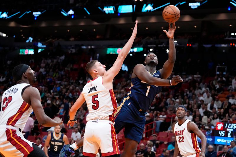 MIAMI, FLORIDA - MARCH 22: Zion Williamson #1 of the New Orleans Pelicans goes up for a shot against Nikola Jovic #5 of the Miami Heat during the third quarter at Kaseya Center on March 22, 2024 in Miami, Florida. NOTE TO USER: User expressly acknowledges and agrees that, by downloading and or using this photograph, User is consenting to the terms and conditions of the Getty Images License Agreement. (Photo by Rich Storry/Getty Images)