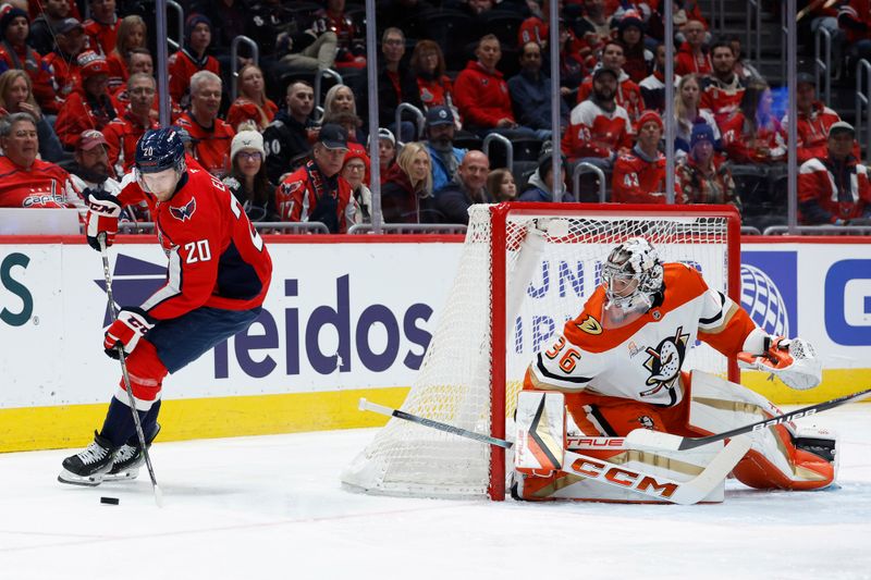 Jan 14, 2025; Washington, District of Columbia, USA;Washington Capitals center Lars Eller (20) skates with the puck behind Anaheim Ducks goaltender John Gibson (36) in the first period  at Capital One Arena. Mandatory Credit: Geoff Burke-Imagn Images