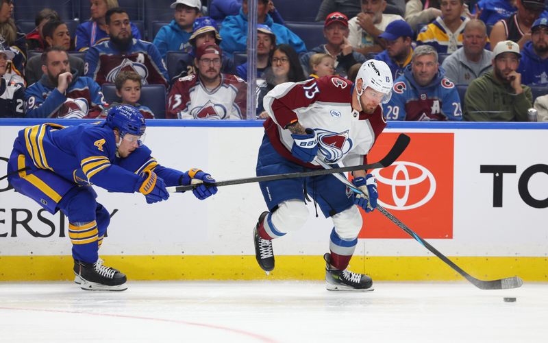 Oct 13, 2025; Buffalo, New York, USA;  Colorado Avalanche right wing Valeri Nichushkin (13) looks to make a pass as Buffalo Sabres defenseman Bowen Byram (4) defends during the third period at KeyBank Center. Mandatory Credit: Timothy T. Ludwig-Imagn Images