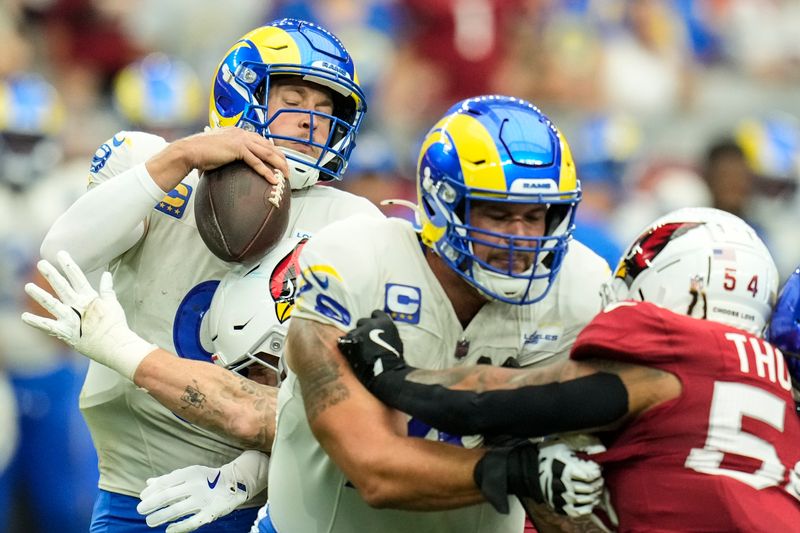 Los Angeles Rams quarterback Matthew Stafford (9) is sacked by Arizona Cardinals linebacker Dennis Gardeck (45) during the first half of an NFL football game, Sunday, Sept. 15, 2024, in Glendale, Ariz. (AP Photo/Ross D. Franklin)