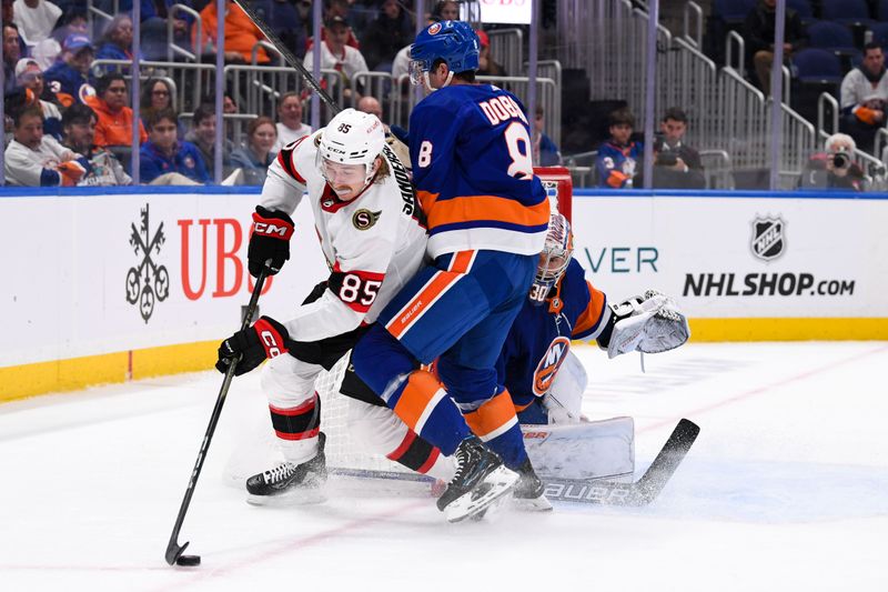 Oct 26, 2023; Elmont, New York, USA; New York Islanders defenseman Noah Dobson (8) defends against Ottawa Senators defenseman Jake Sanderson (85) during the third period at UBS Arena. Mandatory Credit: Dennis Schneidler-USA TODAY Sports