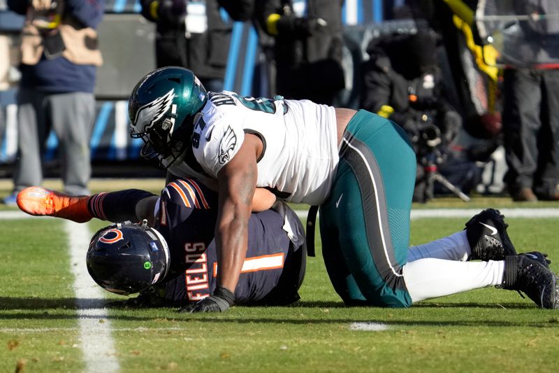 Philadelphia Eagles' Javon Hargrave, right, sacks Chicago Bears' Justin Fields during the second half of an NFL football game, Sunday, Dec. 18, 2022, in Chicago. (AP Photo/Nam Y. Huh)