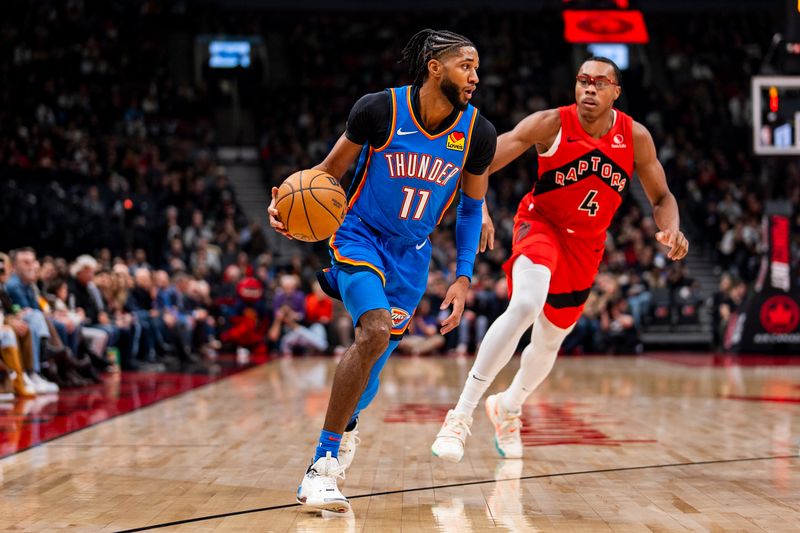 TORONTO, ON - DECEMBER 05: Isaiah Joe #11 of the Oklahoma City Thunder dribbles the ball against Scottie Barnes #4 of the Toronto Raptors at Scotiabank Arena on December 5, 2024 in Toronto, Ontario, Canada. NOTE TO USER: User expressly acknowledges and agrees that, by downloading and/or using this Photograph, user is consenting to the terms and conditions of the Getty Images License Agreement. (Photo by Andrew Lahodynskyj/Getty Images)