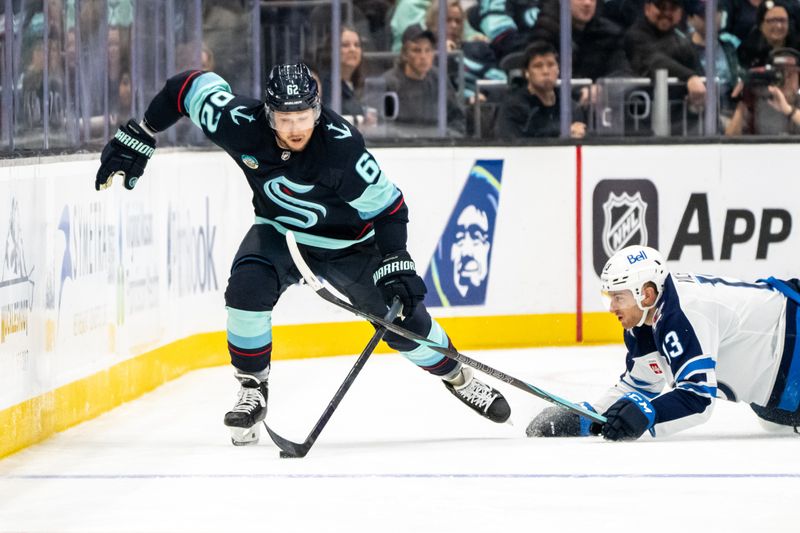 Oct 24, 2024; Seattle, Washington, USA;  Seattle Kraken defenseman Brandon Montour (62) skates against Winnipeg Jets forward Gabriel Vilardi (13) during the third period at Climate Pledge Arena. Mandatory Credit: Stephen Brashear-Imagn Images