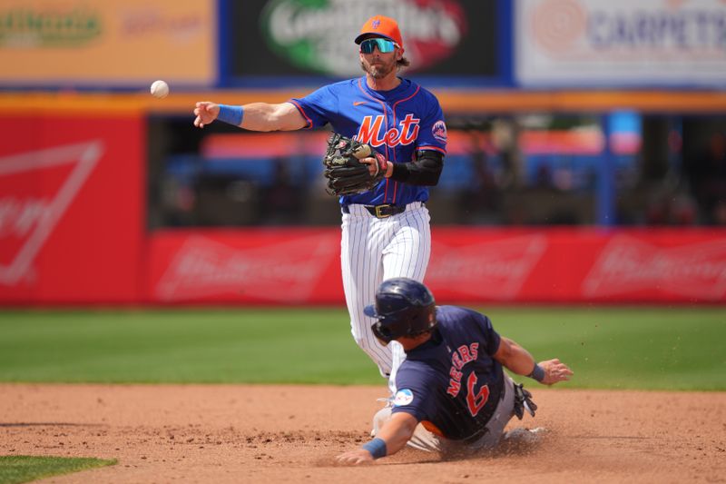 Mar 23, 2024; Port St. Lucie, Florida, USA;  New York Mets second baseman Jeff McNeil (1) turns a double play in the fifth inning as Houston Astros center fielder Jake Meyers (6) slides into second base at Clover Park. Mandatory Credit: Jim Rassol-USA TODAY Sports