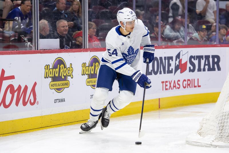 Sep 24, 2024; Ottawa, Ontario, CAN; Toronto Maple Leafs defenseman Nicolas Mattinen (54) skates with the puck in the first period against the Ottawa Senators at the Canadian Tire Centre. Mandatory Credit: Marc DesRosiers-Imagn Images