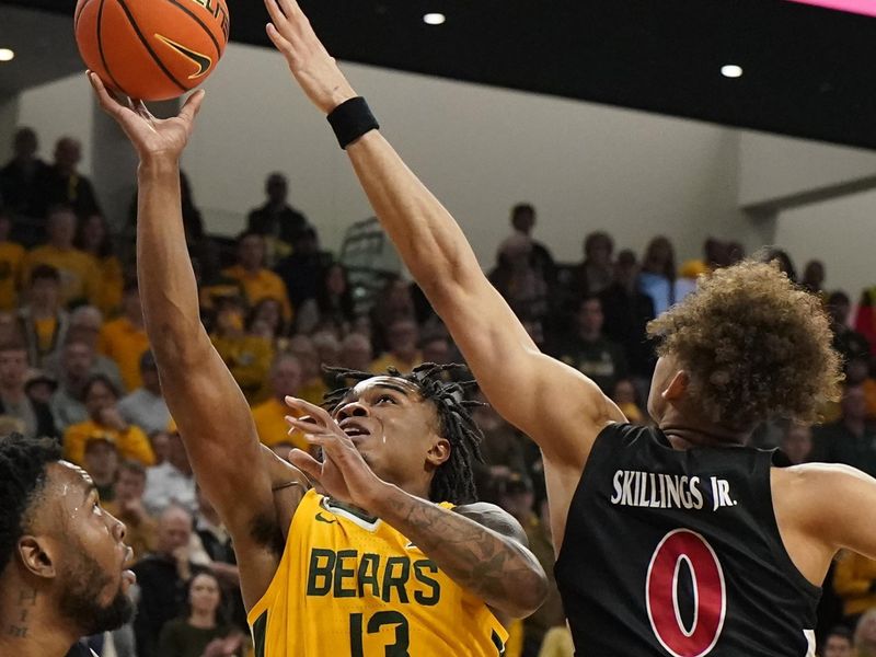 Jan 13, 2024; Waco, Texas, USA; Baylor Bears guard Langston Love (13) shoots over Cincinnati Bearcats guard Dan Skillings Jr. (0) during the second half at Paul and Alejandra Foster Pavilion. Mandatory Credit: Raymond Carlin III-USA TODAY Sports