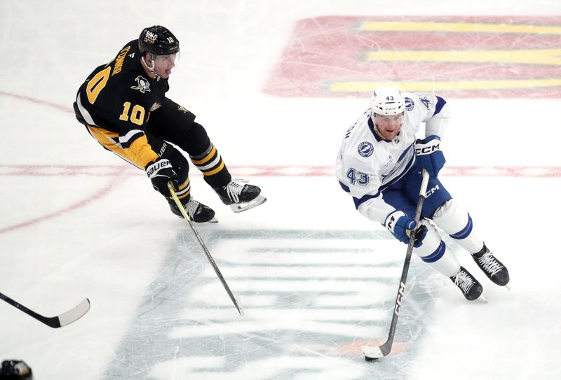 Nov 19, 2024; Pittsburgh, Pennsylvania, USA; Tampa Bay Lightning defenseman Darren Raddysh (43) skates with the puck as Pittsburgh Penguins left wing Drew O'Connor (10) chases during the second period at PPG Paints Arena. Mandatory Credit: Charles LeClaire-Imagn Images