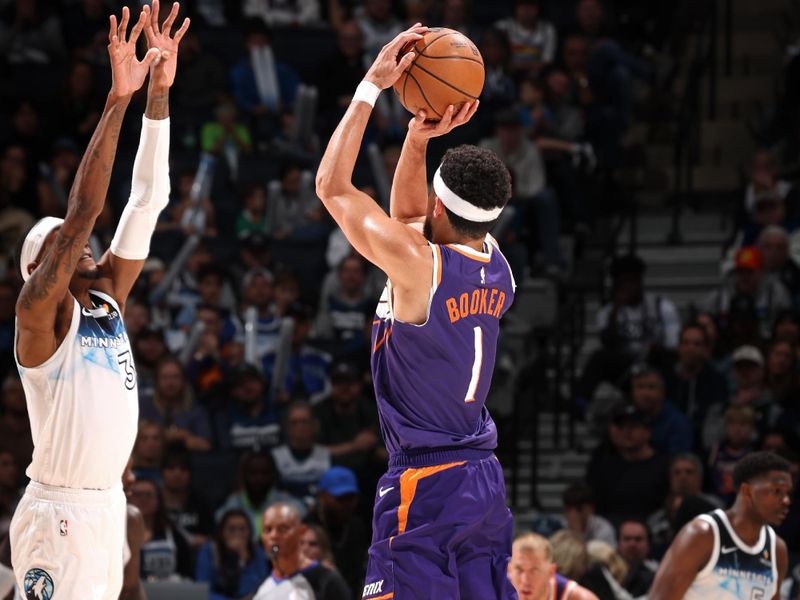 MINNEAPOLIS, MN - NOVEMBER 17: Devin Booker #1 of the Phoenix Suns three point basket during the game against the Minnesota Timberwolves on November 17, 2024 at Target Center in Minneapolis, Minnesota. NOTE TO USER: User expressly acknowledges and agrees that, by downloading and or using this Photograph, user is consenting to the terms and conditions of the Getty Images License Agreement. Mandatory Copyright Notice: Copyright 2024 NBAE(Photo by David Sherman/NBAE via Getty Images)