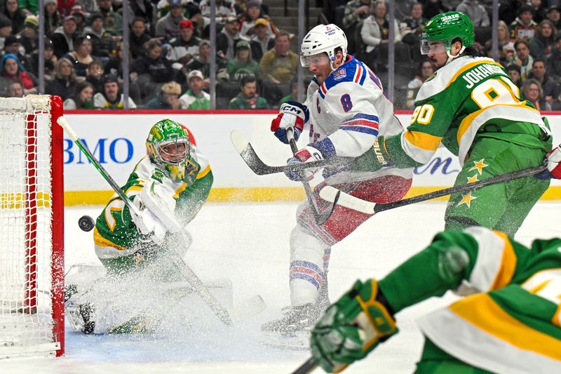 Mar 14, 2026; Saint Paul, Minnesota, USA;  Minnesota Wild goalie Filip Gustavsson (32) makes a save on New York Rangers forward J.T. Miller (8) as forward Marcus Johansson (90) back checks during the first period at Grand Casino Arena. Mandatory Credit: Nick Wosika-Imagn Images