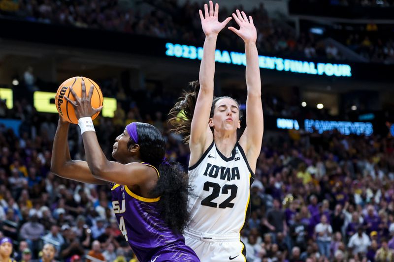 Apr 2, 2023; Dallas, TX, USA; LSU Lady Tigers guard Flau'jae Johnson (4) drives to the basket against Iowa Hawkeyes guard Caitlin Clark (22) in the first half during the final round of the Women's Final Four NCAA tournament at the American Airlines Center. Mandatory Credit: Kevin Jairaj-USA TODAY Sports