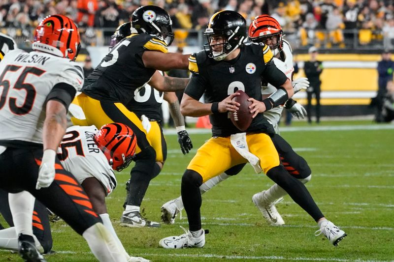 Pittsburgh Steelers quarterback Mason Rudolph (2) scrambles out of the pocket during the first half of an NFL football game against the Cincinnati Bengals in Pittsburgh, Saturday, Dec. 23, 2023. (AP Photo/Gene J. Puskar)