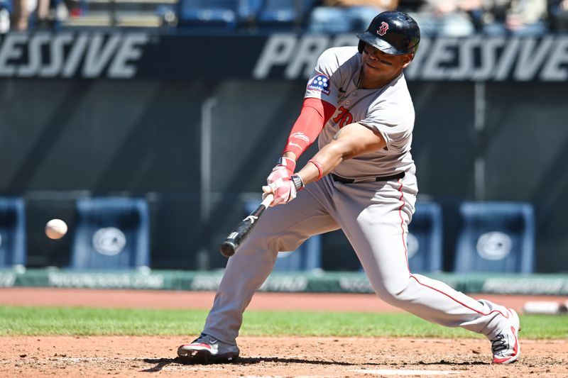 Apr 27, 2025; Cleveland, Ohio, USA; Boston Red Sox designated hitter Rafael Devers (11) hits a single during the fifth inning against the Cleveland Guardians at Progressive Field. Mandatory Credit: Ken Blaze-Imagn Images