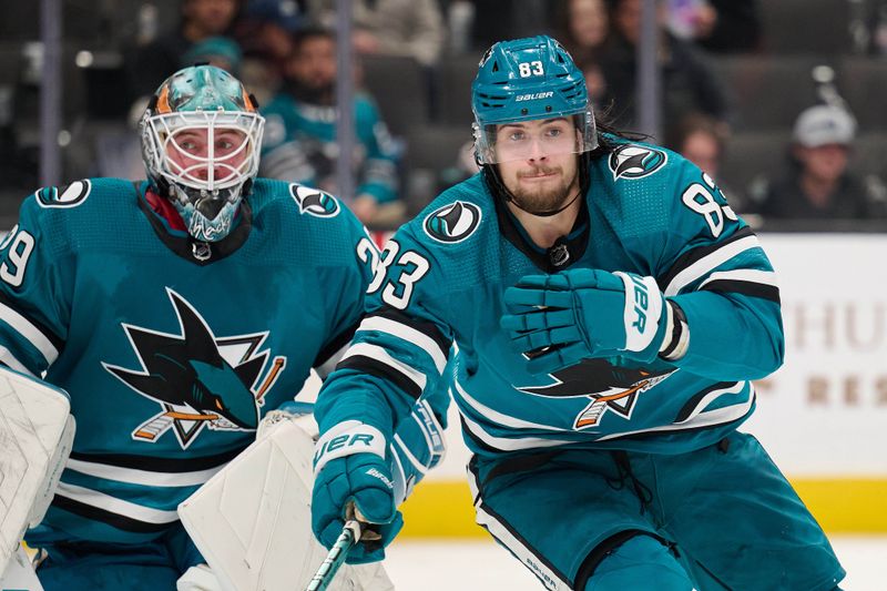 Dec 12, 2023; San Jose, California, USA; San Jose Sharks defenseman Nikita Okhotiuk (83) and Mackenzie Blackwood (29) skate against the Winnipeg Jets during the third period at SAP Center at San Jose. Mandatory Credit: Robert Edwards-USA TODAY Sports