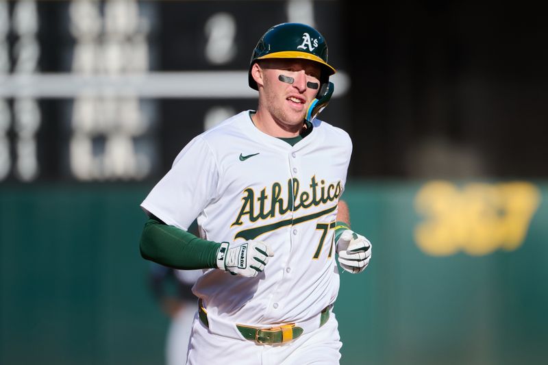 May 4, 2024; Oakland, California, USA; Oakland Athletics infielder Brett Harris (77) runs the bases after hitting a one-run home run against the Miami Marlins for his first MLB career hit during the fourth inning at Oakland-Alameda County Coliseum. Mandatory Credit: Robert Edwards-USA TODAY Sports